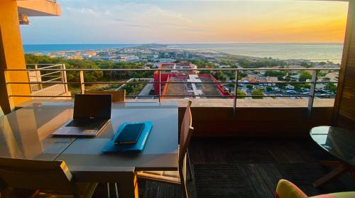 a laptop computer sitting on a table on a balcony at Luxueux T3 Piscine et Vue Somptueuse in Sète