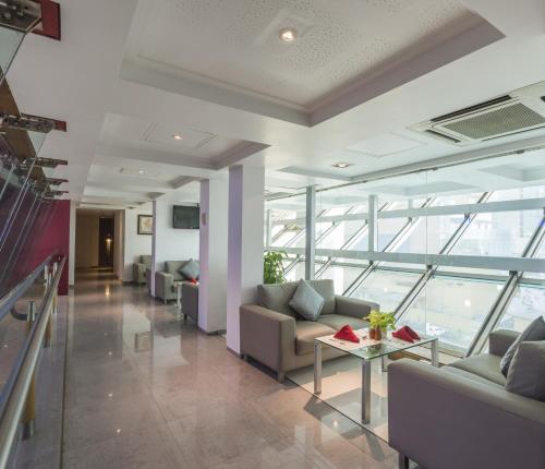 a lobby with couches and a table in a building at The Regenza By Tunga in Navi Mumbai