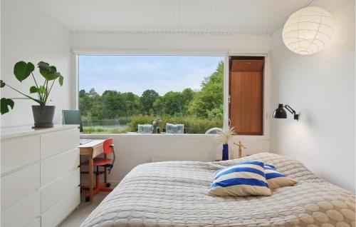 a bedroom with a bed and a desk and a window at Cozy Home In Niv With Kitchen in Nivå