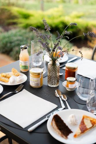 a black table with plates of food on it at Hortus Natural Living in Todi