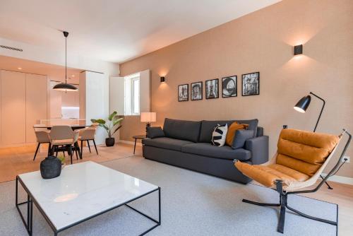 a living room with a couch and a table at Liberdade Elegance W/Rooftop Pool by LovelyStay in Lisbon