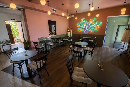 a restaurant with tables and chairs and a colorful wall at Lemon Market rooms in Zagreb