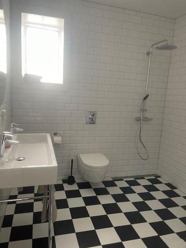 a bathroom with a toilet and a sink and a shower at leilighet in Stavanger