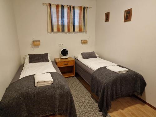 2 camas individuais num quarto com uma janela em Húsid Guesthouse em Reykholt
