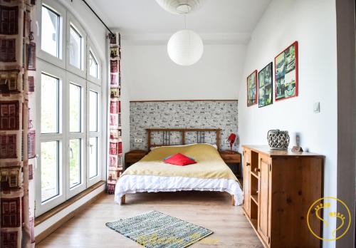 a bedroom with a bed and large windows at Golden Deevi in Sălişte
