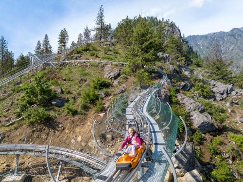 a woman riding a roller coaster at the theme park at Pine Tree Cottage by NW Comfy Cabins in Leavenworth