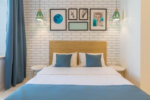 a bedroom with a bed and pictures on the wall at Idea Design Apart-Hotel in Kyiv