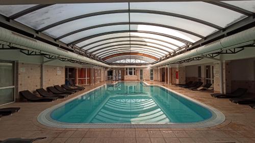 a large swimming pool with a domed ceiling at DAZ Dunai Apartman Zalakros in Zalakaros