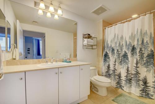 a bathroom with a toilet and a shower curtain at Amazing One-bedroom In Casa Costa!beach Pass Inc! in Boynton Beach