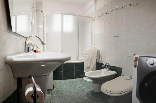 a bathroom with a sink and a toilet at Casa Ambra mare in Bordighera