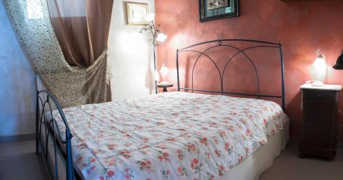 a bedroom with a bed with a red wall at Casa Ambra mare in Bordighera