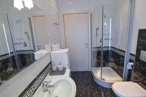 a bathroom with a toilet and a sink and a tub at Villa Alba, Apartment Katja - with swimming pool in Ičići