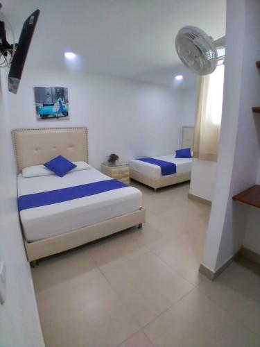 a bedroom with two beds and a fan at Hotel San Fernandos Plaza in San Rafael