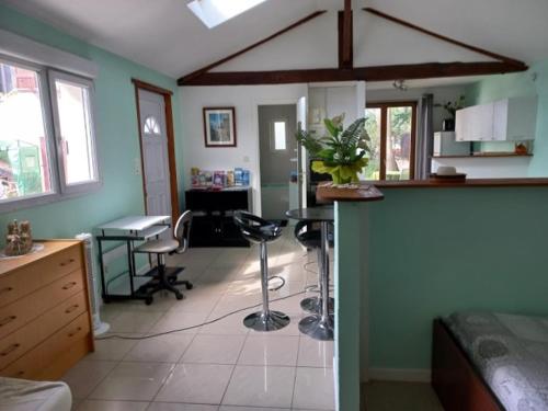 a room with a kitchen with a table and chairs at Jacques et Paola Chanis in Ambérieu-en-Bugey