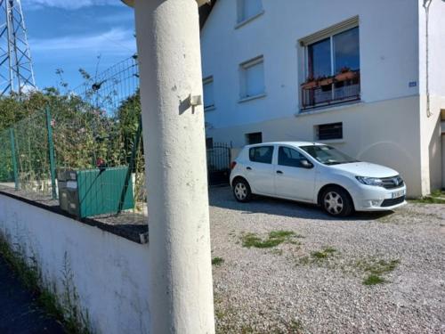 a white car parked in front of a building at Jacques et Paola Chanis in Ambérieu-en-Bugey
