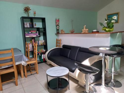 a living room with a couch and a table and chairs at Jacques et Paola Chanis in Ambérieu-en-Bugey
