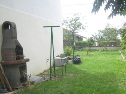 a yard with a fireplace and a house at Jacques et Paola Chanis in Ambérieu-en-Bugey