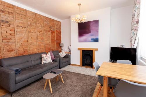 a living room with a couch and a table at Apartment 4 at Number 8 in City centre with kitchenette in Kent