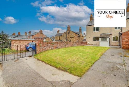 a large yard in a house with a sign that reads your choice save at Lovely detached Cottage, Flint in Flint