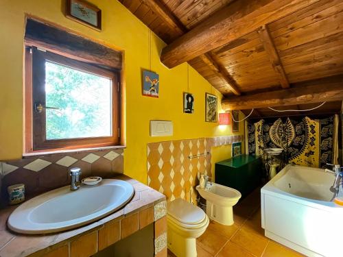 a bathroom with a tub and a sink and a toilet at Country House tra lago e mare a Sud di Roma in Campoleone
