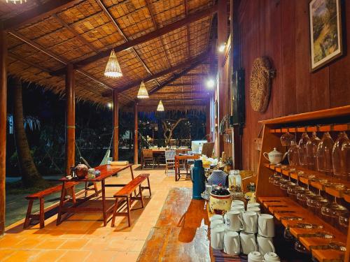 a large room with tables and chairs in a building at Ba Danh Homestay & Kitchen - Ben Tre Mekong in Ben Tre