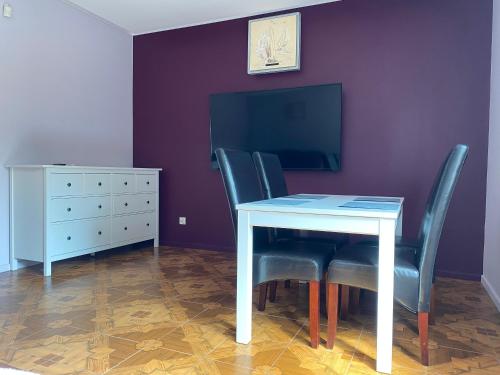 a dining room table with two chairs and a dresser at Dolores in Giżycko