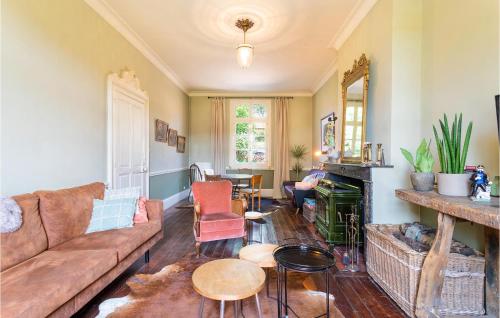 a living room with a couch and a fireplace at Beautiful Home In Fressin With Kitchen in Fressin