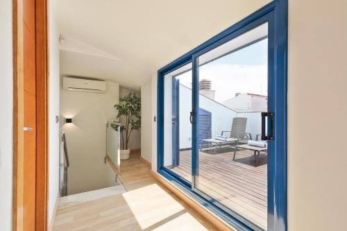 a sliding glass door leading to the balcony of a house at Lucas House Apartments by Sitges Group in Sitges