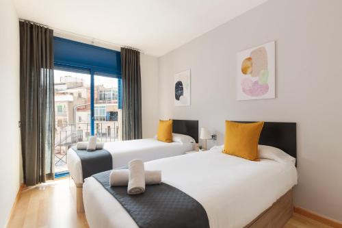 Postel nebo postele na pokoji v ubytování Lucas House Apartments by Sitges Group
