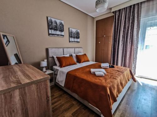 a bedroom with a large bed and a window at Silver Central Apartment in Volos