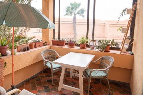 a table and chairs in front of a window with plants at Casa Harmonia in La Pared