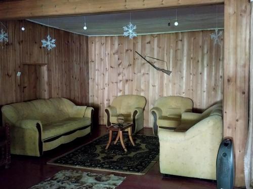 a living room with two couches and a table at Guesthouse Leno in Tsaldashi