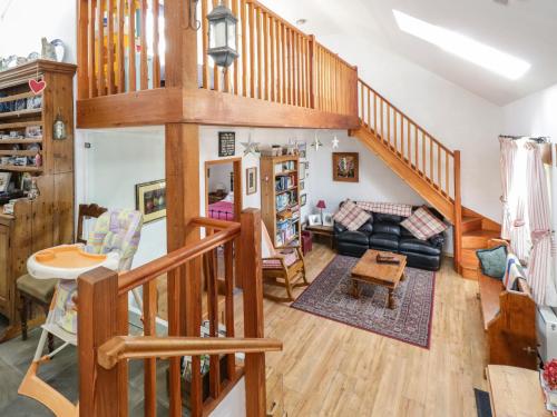 a living room with a staircase and a living room at Old Mike's Cottage in Westport
