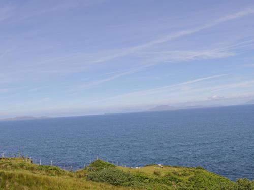 a view of the ocean from the top of a hill at Old Mike's Cottage in Westport