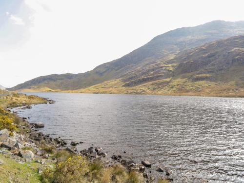 a body of water with mountains in the background at Old Mike's Cottage in Westport