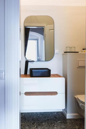 a bathroom with a sink and a mirror at Sia Boutique Aparthotel in Sibiu