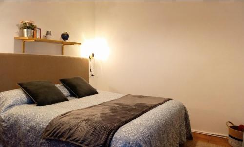 a bedroom with a bed with two pillows on it at Large flat in the hills of Menaggio in Menaggio