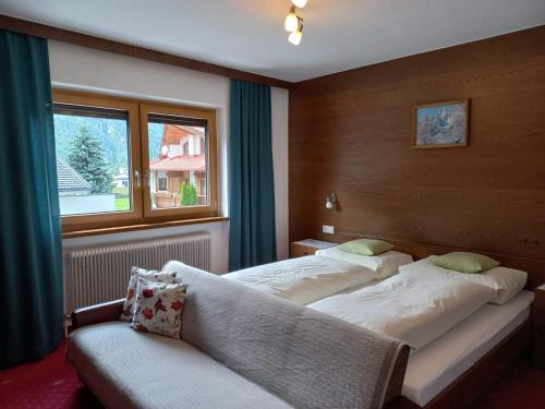 1 Schlafzimmer mit 2 Betten und einem Fenster in der Unterkunft Ferienwohnungen Plattner in Längenfeld