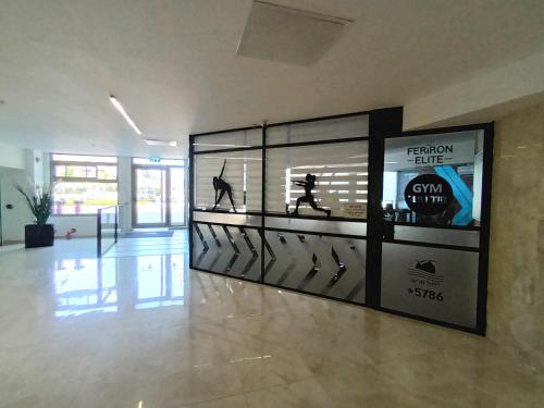 a large display case in a lobby with a display of items at Beach Suite Israel - Indoor Pool, Best View, Gym, Massage Chair, Spa ביץ סוייט ישראל - נוף ים מאלף, בריכה מקורה, כיסא מסאז, חדר כושר וספא in Ashqelon