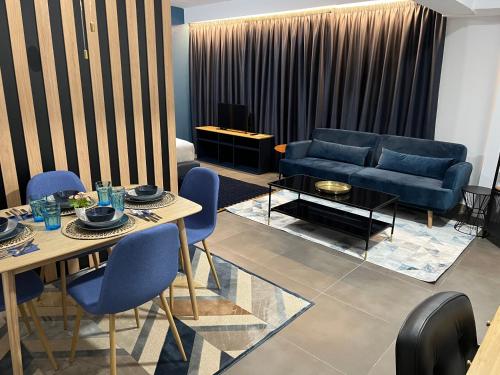 a living room with a couch and a table and chairs at Modular Suites Alfonso Gómez in Madrid