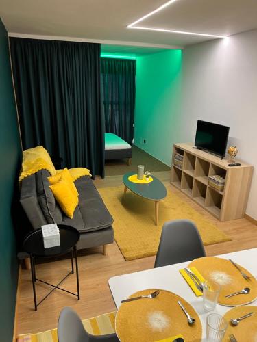 a living room with a couch and a table at Modular Suites Alfonso Gómez in Madrid