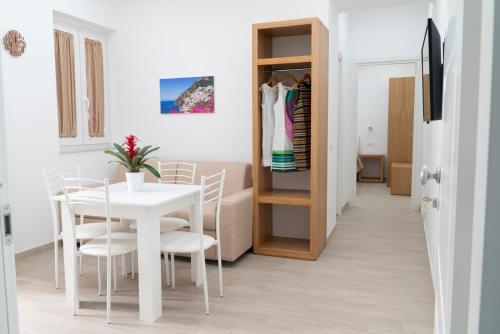 - une salle à manger blanche avec une table et des chaises blanches dans l'établissement Casa Mia Apartments, à Sorrente