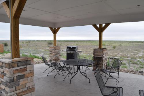 a patio with a table and chairs and a grill at Microtel Inn and Suites Pecos in Pecos