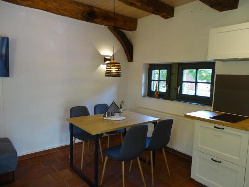 eine Küche mit einem Tisch und Stühlen im Zimmer in der Unterkunft Ferienhaus Bultperle in Hüde