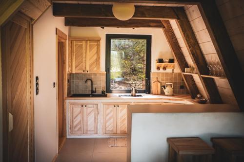 eine Küche mit einem Waschbecken und einem Fenster in der Unterkunft Grzechatka in Wetlina