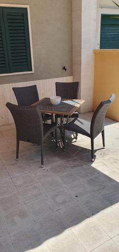 a wooden table and chairs on a patio at Gentilcasa in Monopoli