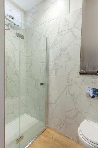 a bathroom with a glass shower with a toilet at Apartment 5 at Number 8: 1 bedroom, sofa bed in lounge, kitchenette & walk-in shower in Kent