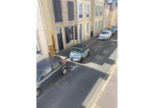 a group of cars parked on a city street at Le cosy-chic, 2 min à pied cathédrale , Jacobins in Le Mans