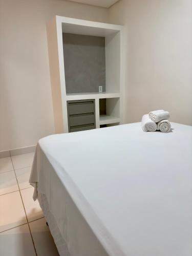 a bedroom with a white bed with towels on it at Acoara Beco Doce in Jericoacoara