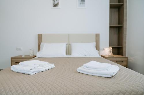 a bedroom with a bed with white towels on it at Apartments Christina in Perdika